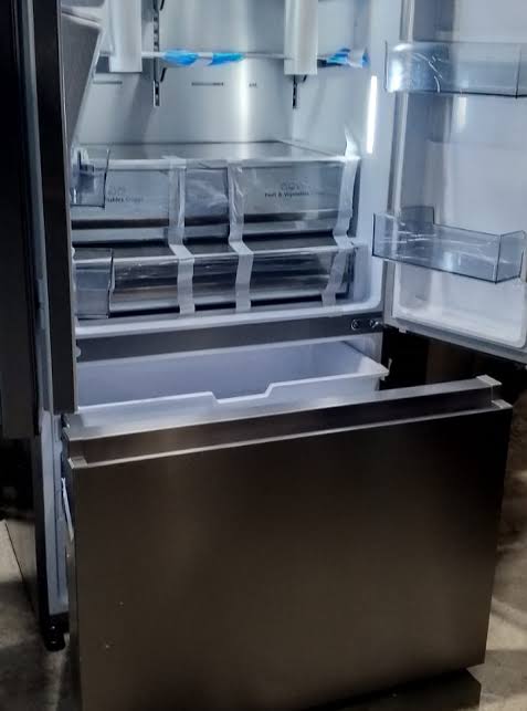 Open French-door refrigerator installation at a Silver Lakes architectural home